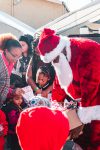 Santa hands toys to young kids